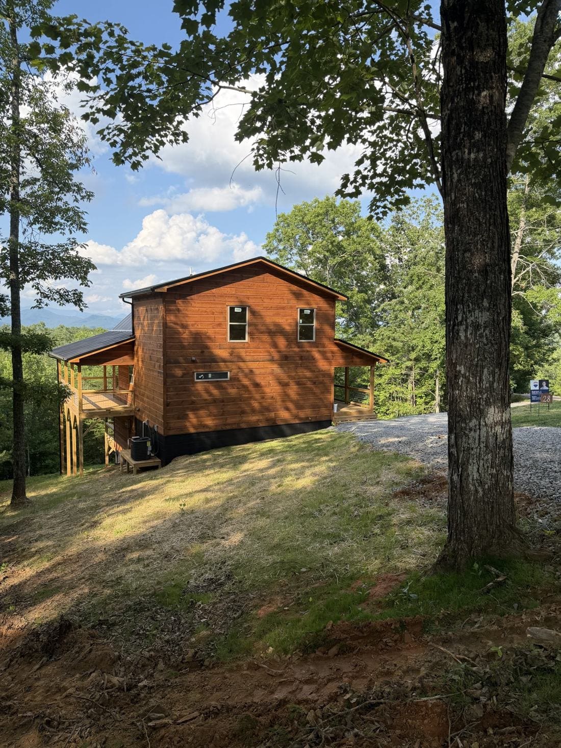 Finished cedar-sided mountain home with decks and a gravel drive