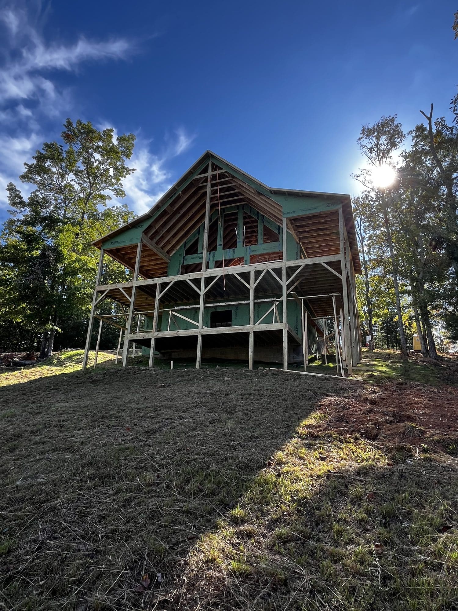 Two-story home with stacked covered porches on a hillside