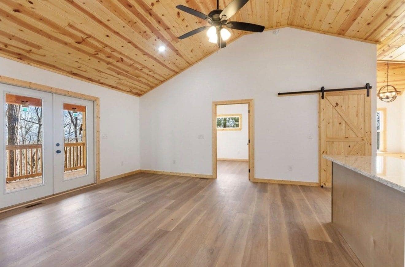 Vaulted room with pine ceiling, ceiling fan and windows