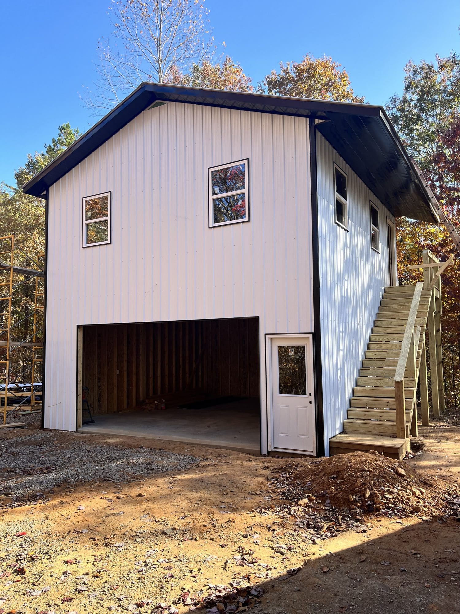 Two-story metal-sided garage building with exterior stairs
